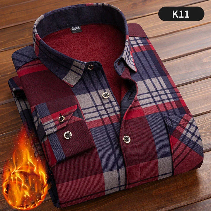 Folded warm flannel plaid shirt in red blue and gray on wooden surface with fire graphic, style K11