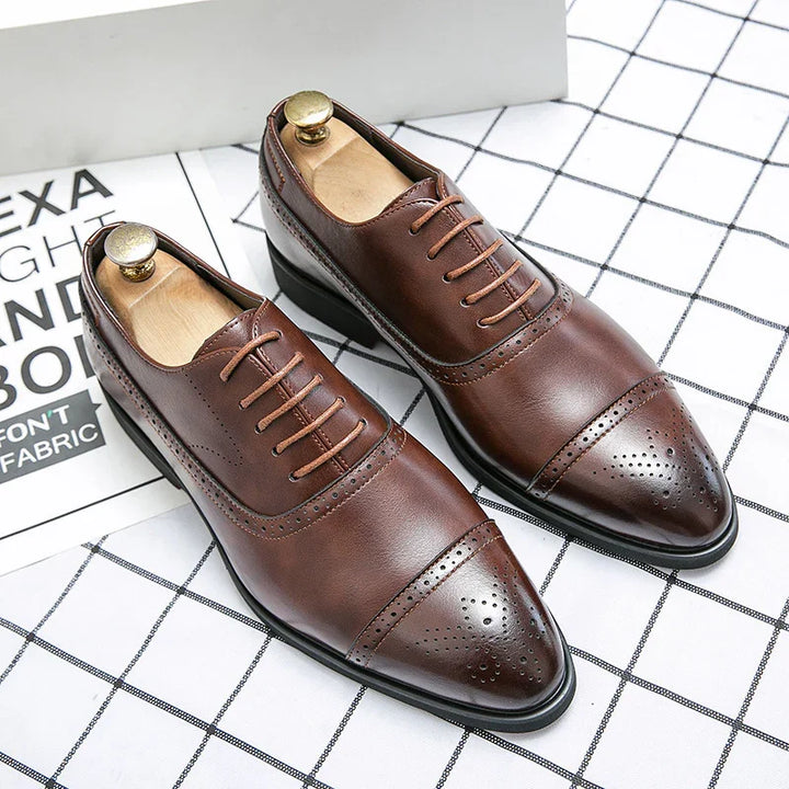 Brown leather men's dress shoes with brogue detailing and lace-up design on checkered fabric