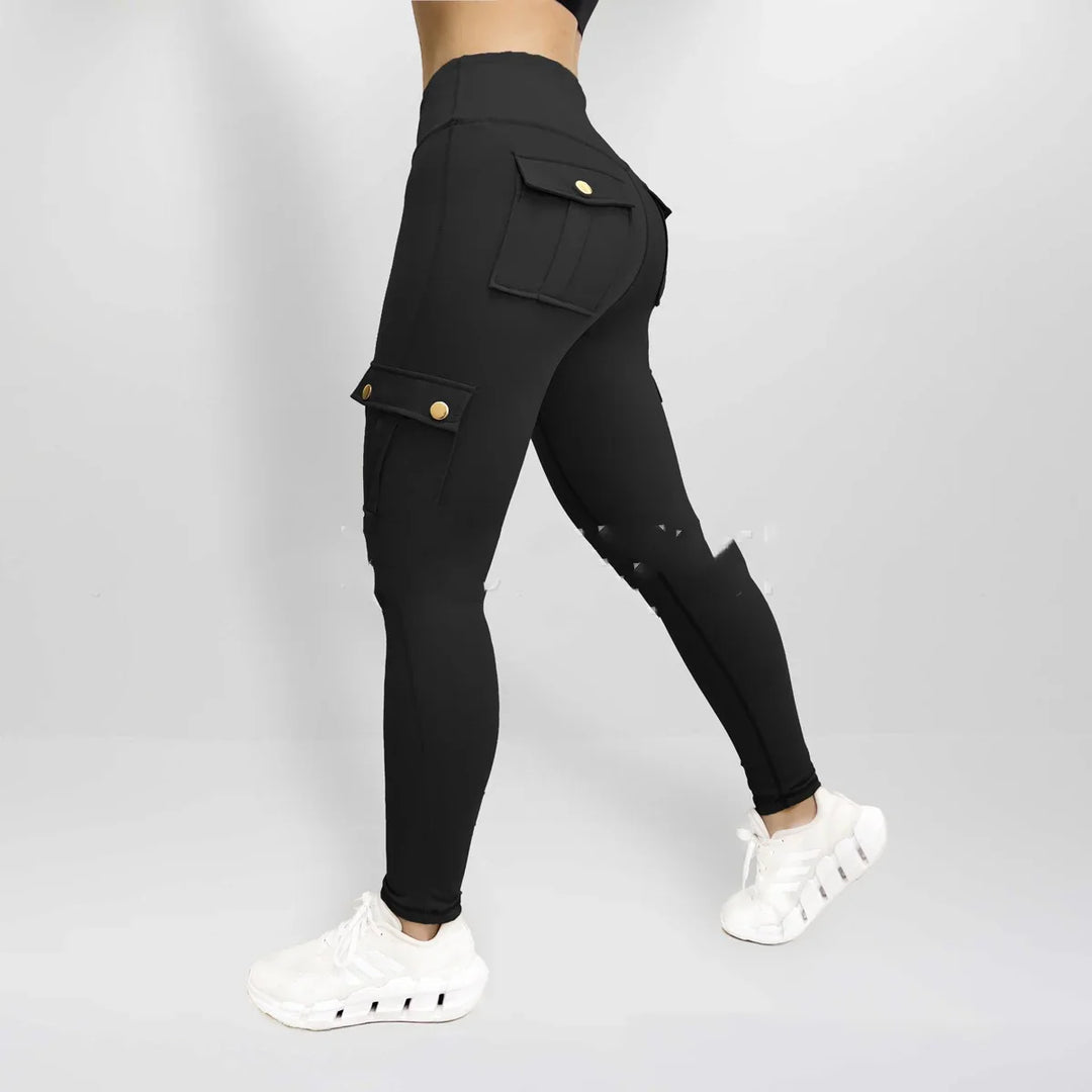 Woman wearing black high-waisted cargo leggings with gold button pockets and white sneakers