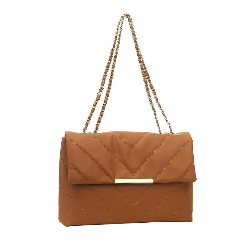 Brown quilted leather shoulder bag with gold chain strap and rectangular metal accent