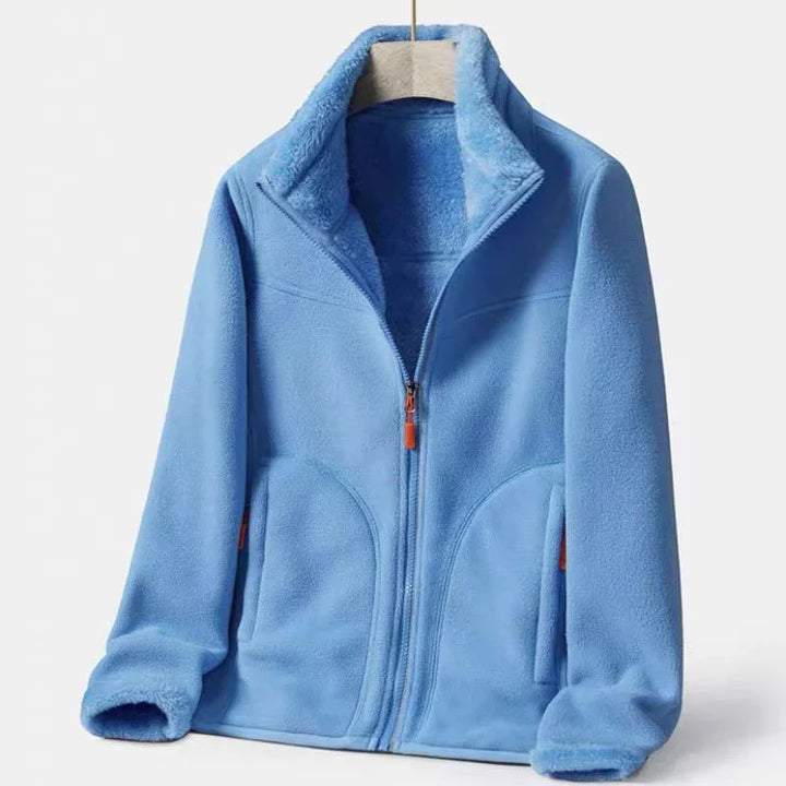 Light blue fleece jacket with front zipper and high collar on beige hanger