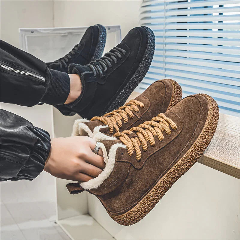 Pair of stylish winter sneakers in black and brown with fur lining and textured soles