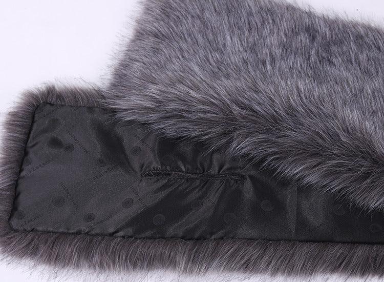 Close-up of gray faux fur fabric with smooth black silk lining featuring subtle brand text pattern