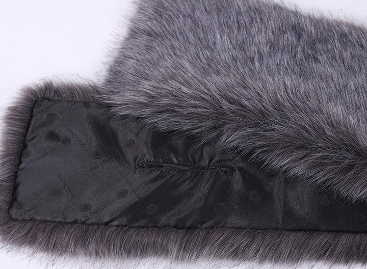 Close-up of gray faux fur fabric with smooth black silk lining featuring subtle brand text pattern