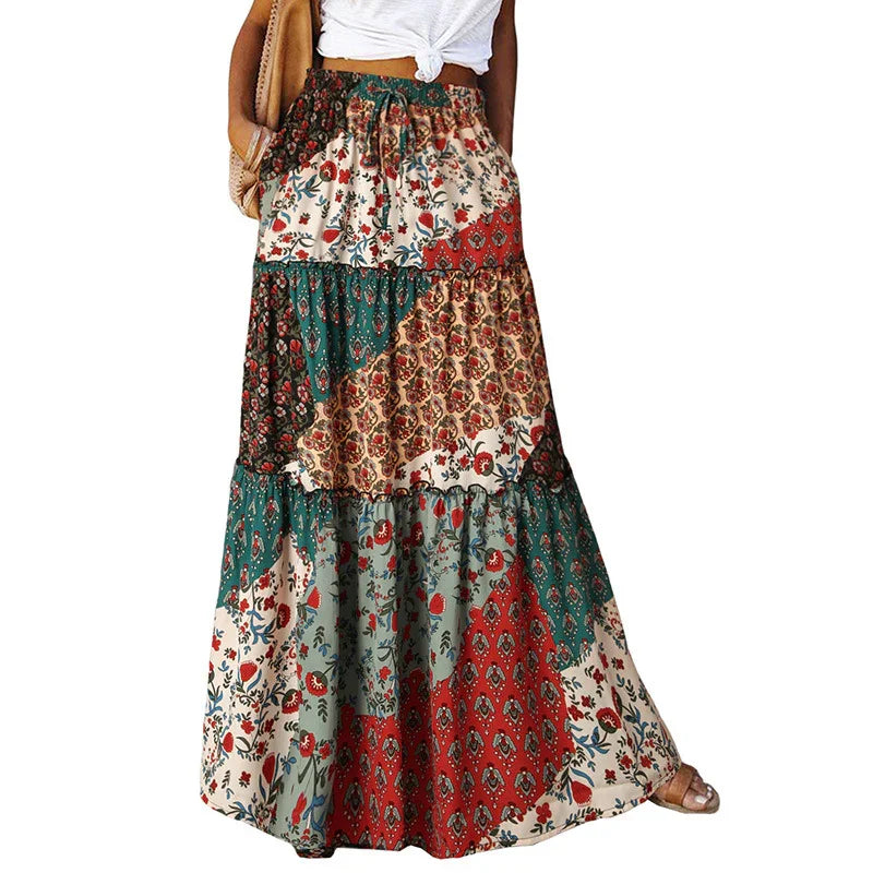 Woman wearing boho patchwork floral print maxi skirt in earthy tones with a white tied crop top