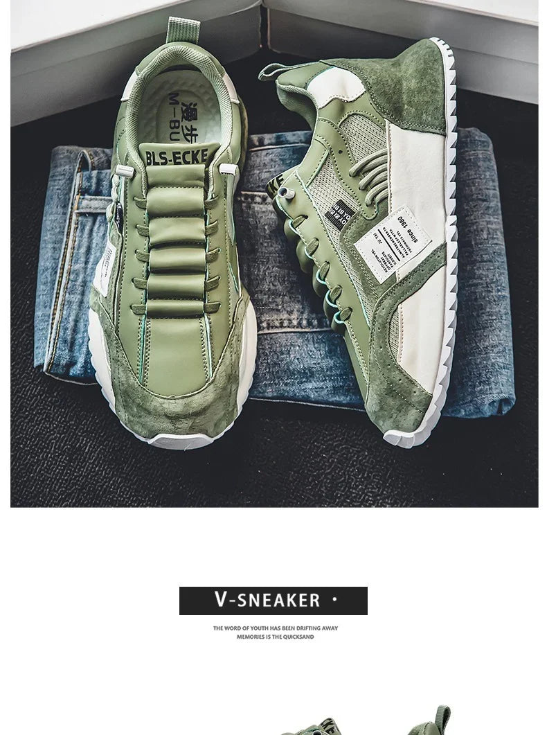 Green and white modern V-sneaker shoes placed on folded blue denim jeans on a dark carpet