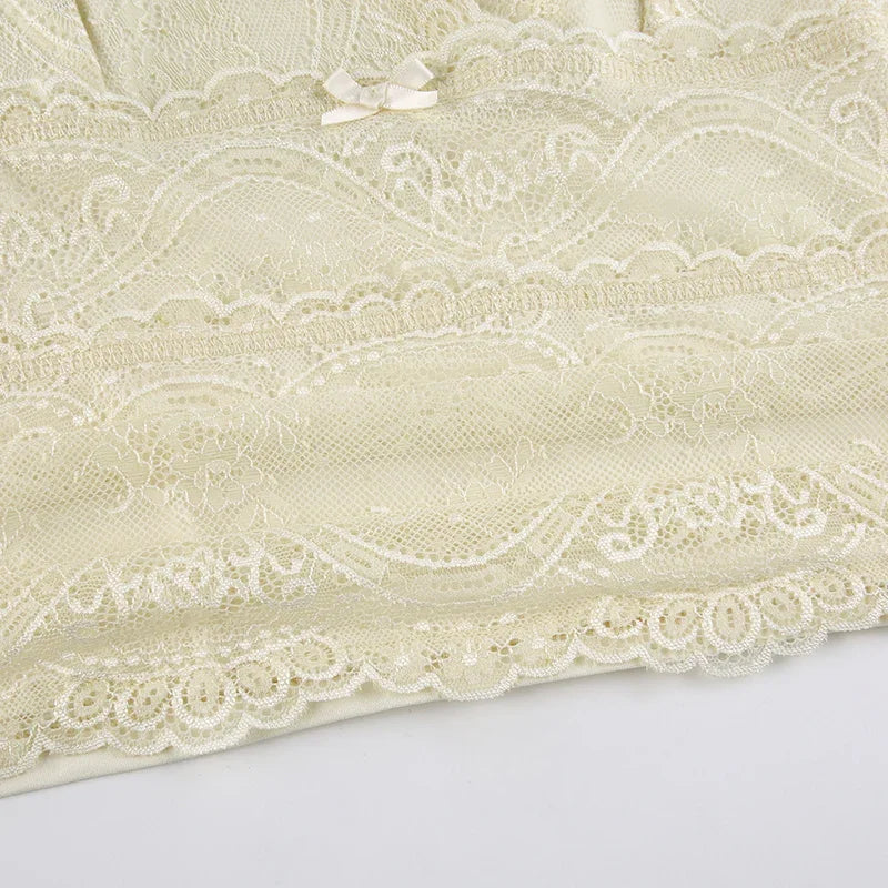 Ivory lace lingerie fabric with floral patterns and small satin bow detail