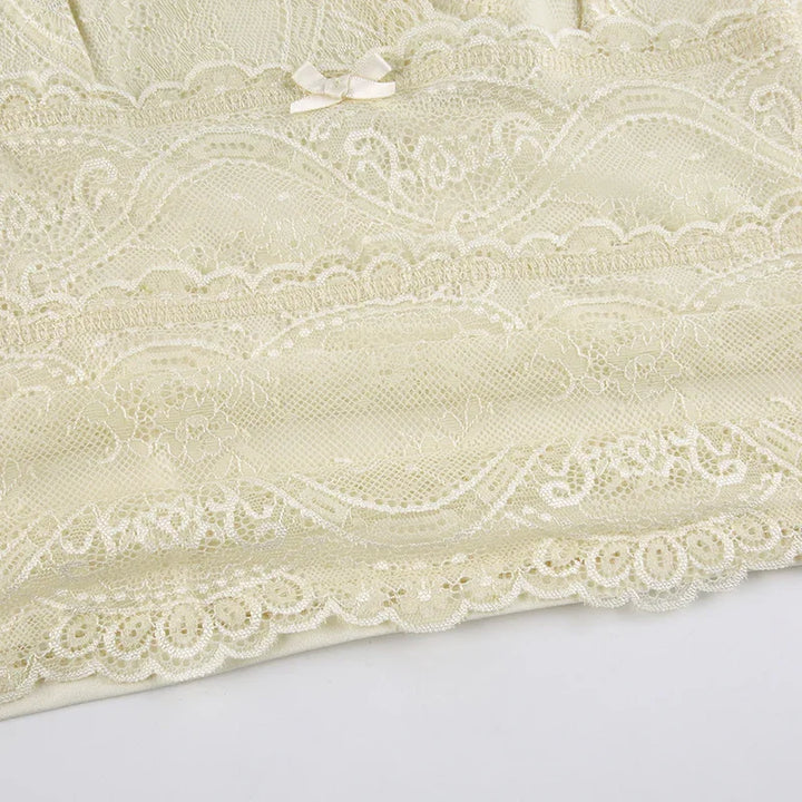 Ivory lace lingerie fabric with floral patterns and small satin bow detail