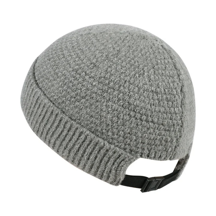 Gray knitted wool cycling cap with adjustable black strap on white background