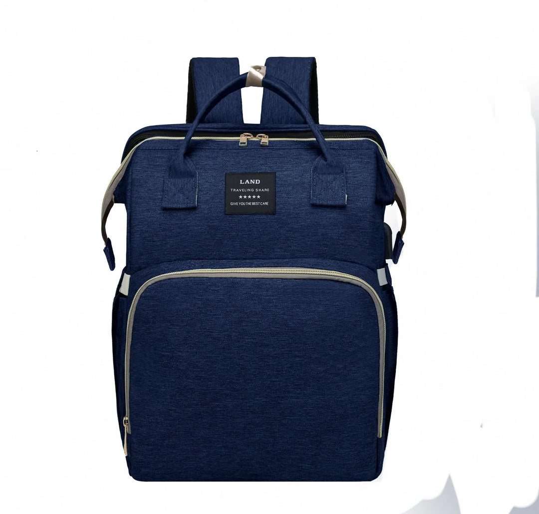 Navy blue travel backpack with front zipper pocket and top handles on white background