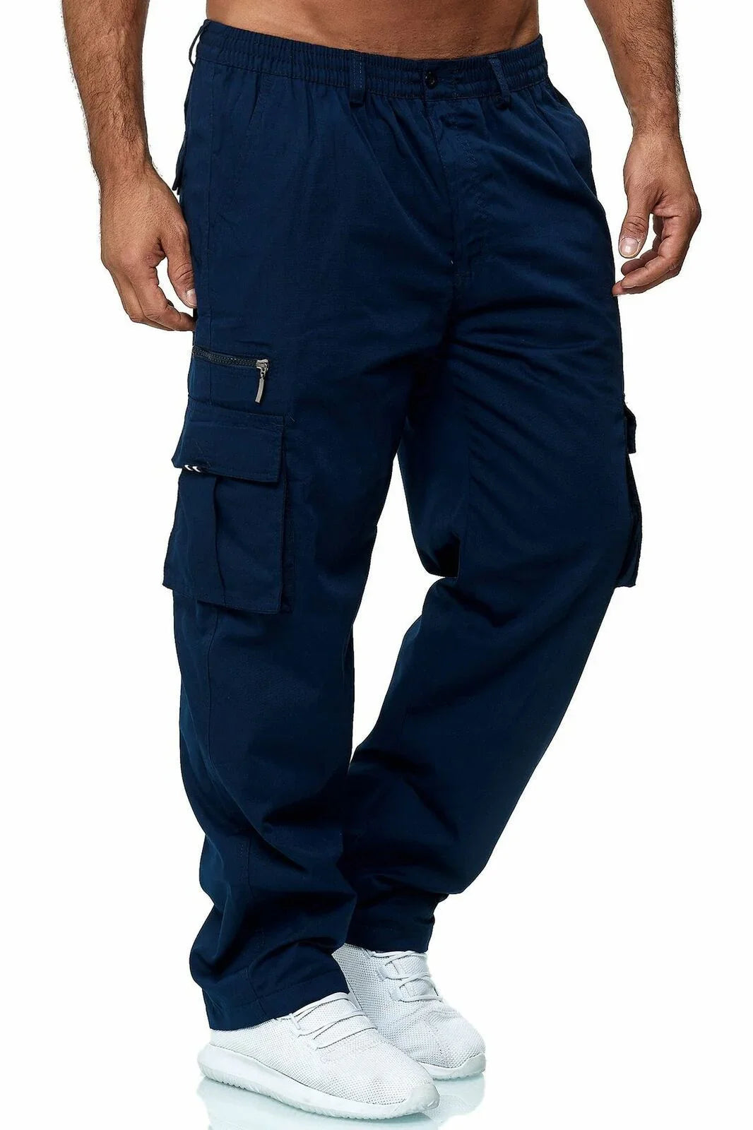 Men's navy blue cargo pants with multiple pockets and zipper detail, paired with white sneakers