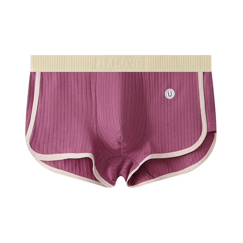 Purple ribbed men's boxer briefs with beige waistband and trim, featuring logo patch on front