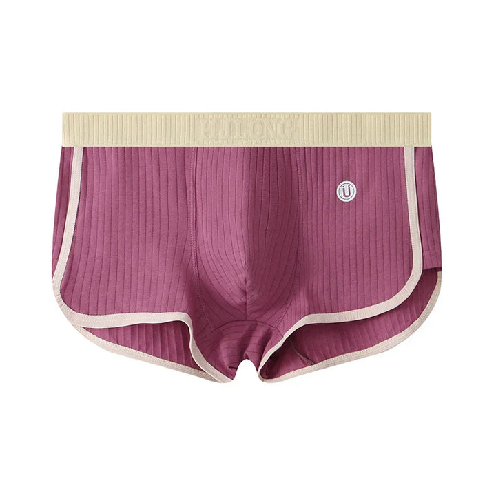 Purple ribbed men's boxer briefs with beige waistband and trim, featuring logo patch on front
