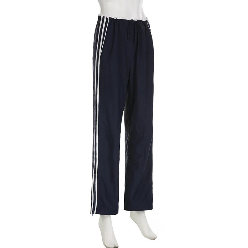 navy blue athletic track pants with white side stripes and drawstring waist