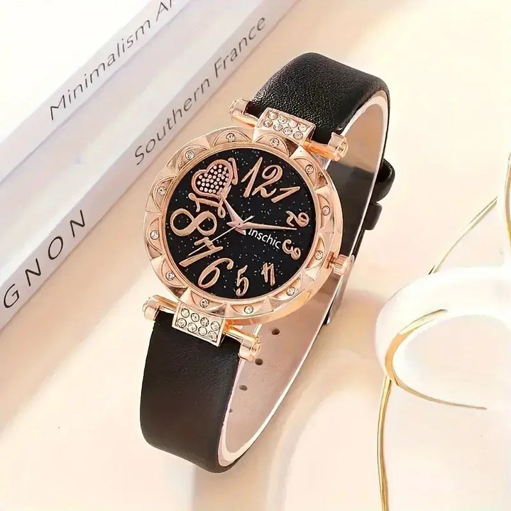 Elegant women's wristwatch with black leather strap, gold-tone case with rhinestones, and black dial with oversized gold numbers