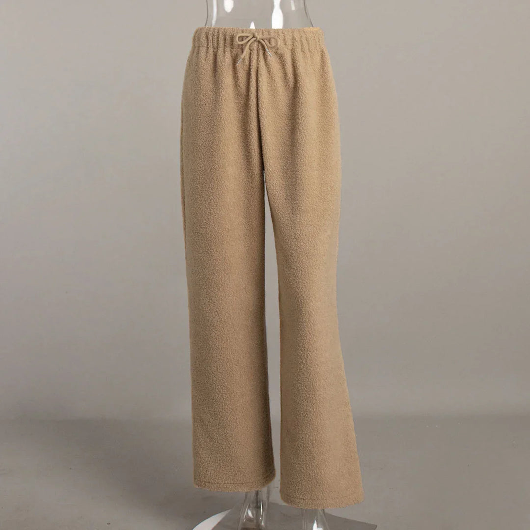 Beige fleece drawstring pants displayed on transparent mannequin against gray background