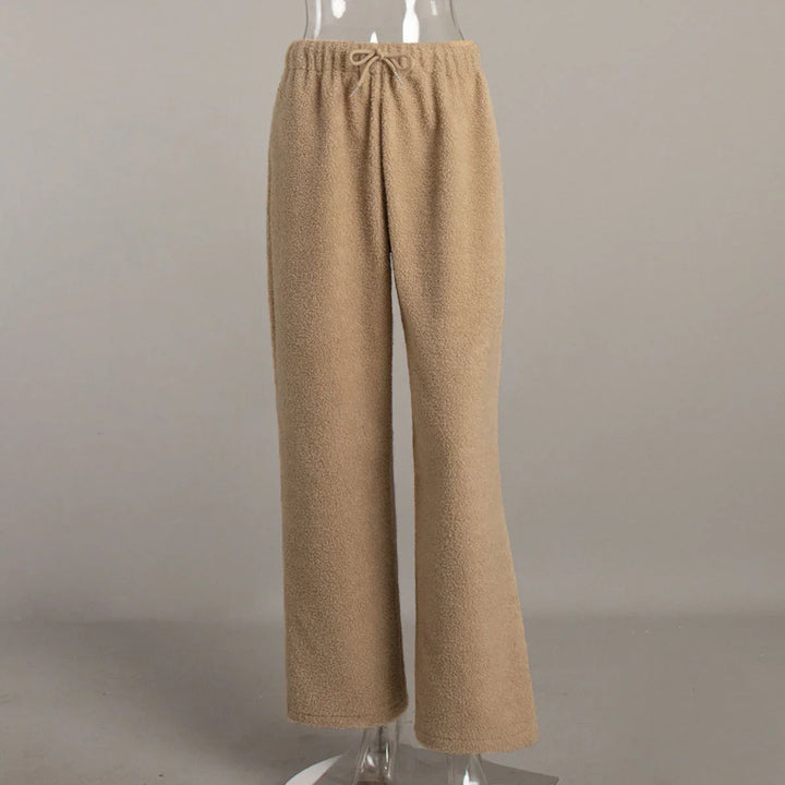 Beige fleece drawstring pants displayed on transparent mannequin against gray background