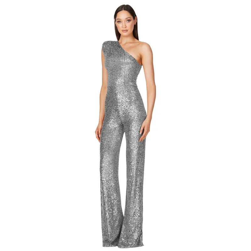 Woman wearing a silver one-shoulder sequined jumpsuit with flared legs on white background