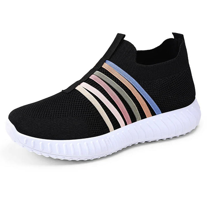 Black slip-on knit sneaker with white sole and pastel multicolor stripes on side