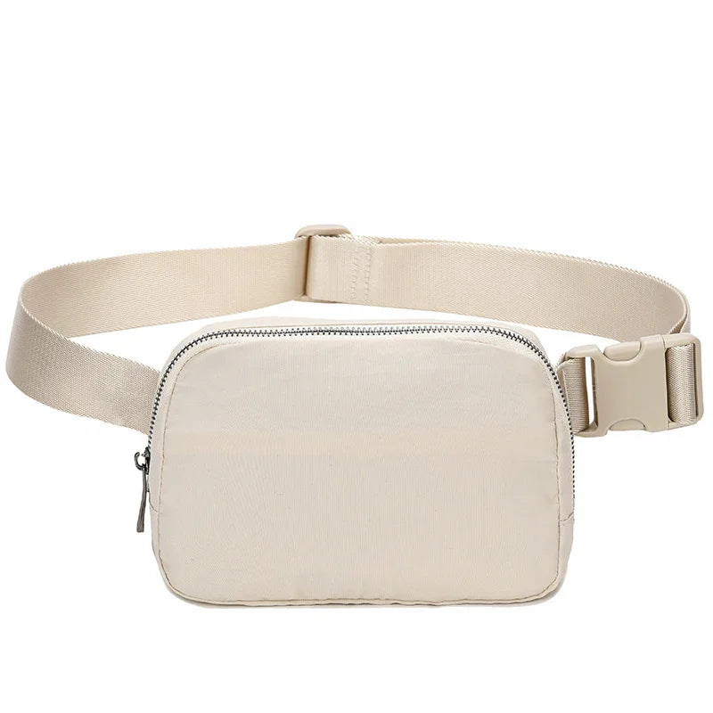 Beige nylon waist bag with adjustable strap and zipper closure on white background