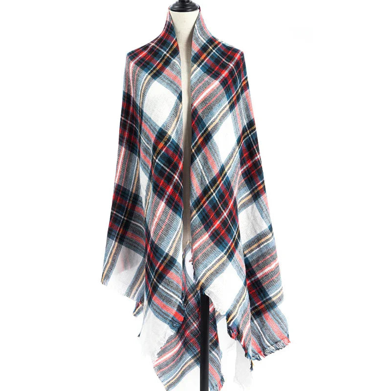 Plaid wool shawl with red, blue, white, and black tartan pattern displayed on dress form