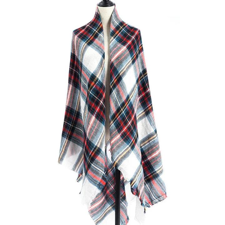 Plaid wool shawl with red, blue, white, and black tartan pattern displayed on dress form