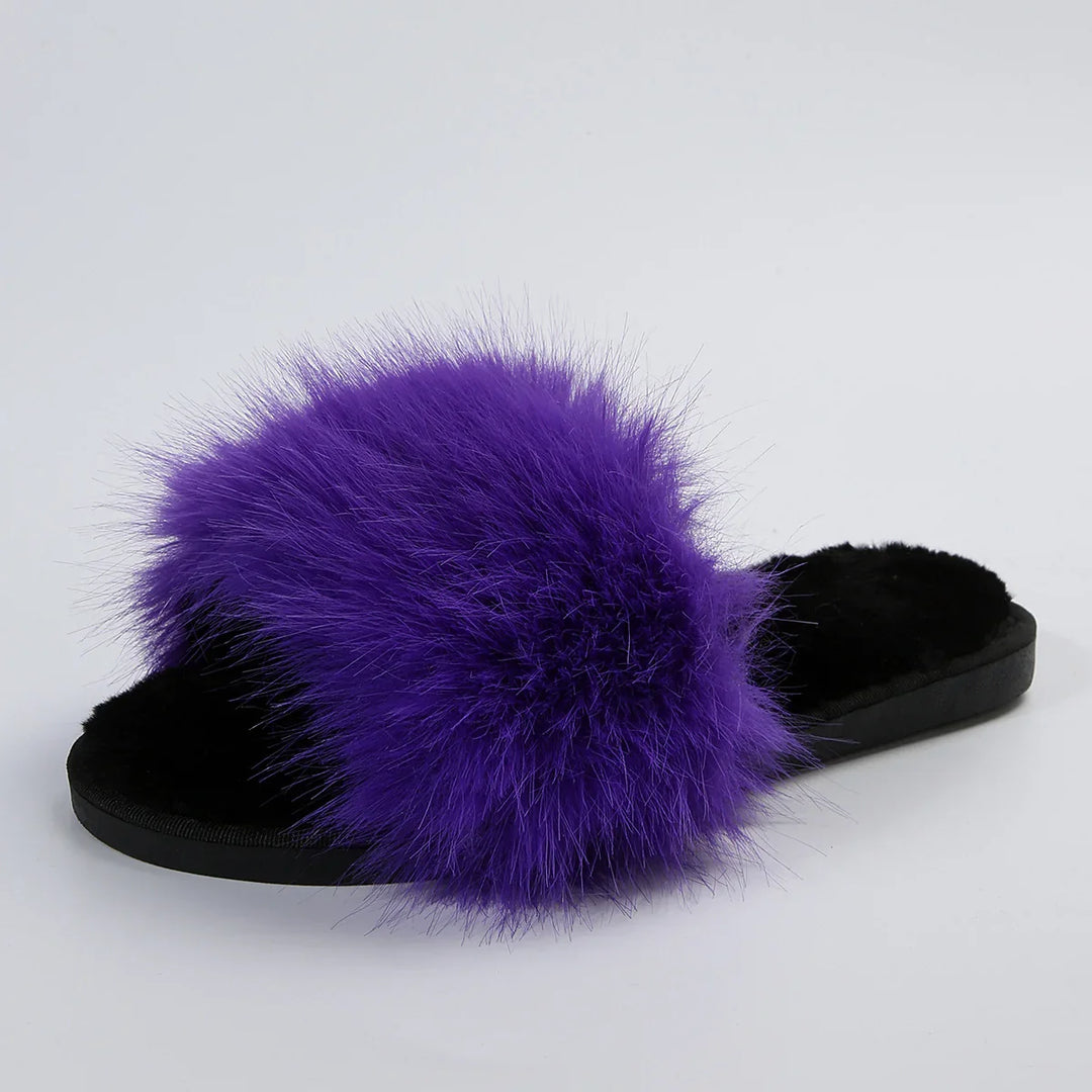 Black slide slipper with vibrant purple fluffy fur strap on white background