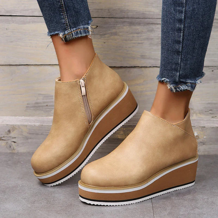 Beige platform wedge ankle boots with side zipper worn with frayed hem denim jeans