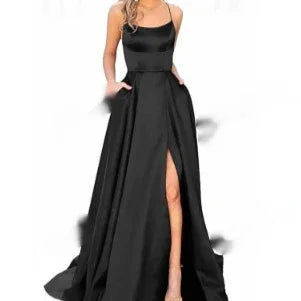 Elegant black satin evening gown with thin straps and thigh-high slit on model