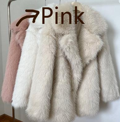 Soft faux fur coats in pink and cream colors hanging on a metal rack against a white wall