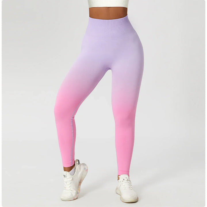 Woman wearing high waisted purple pink ombre seamless leggings and white sneakers