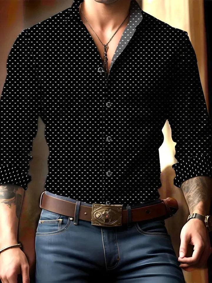 Man wearing black patterned button-up shirt paired with jeans, brown belt with ornate buckle, and necklace