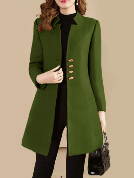 woman wearing stylish olive green long coat with gold buttons, black turtleneck and pants, carrying black handbag
