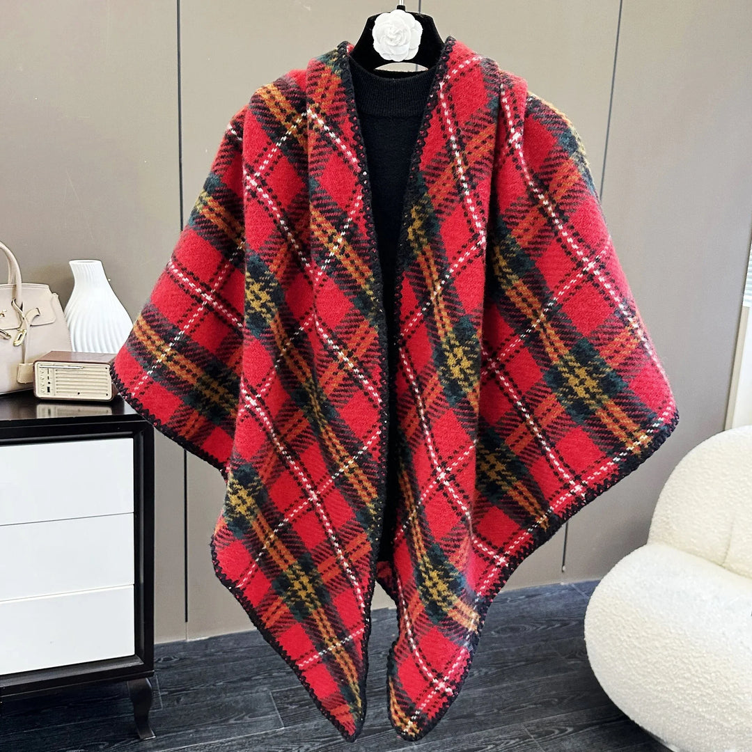 Red plaid wool shawl with black trim displayed on a mannequin in a modern room
