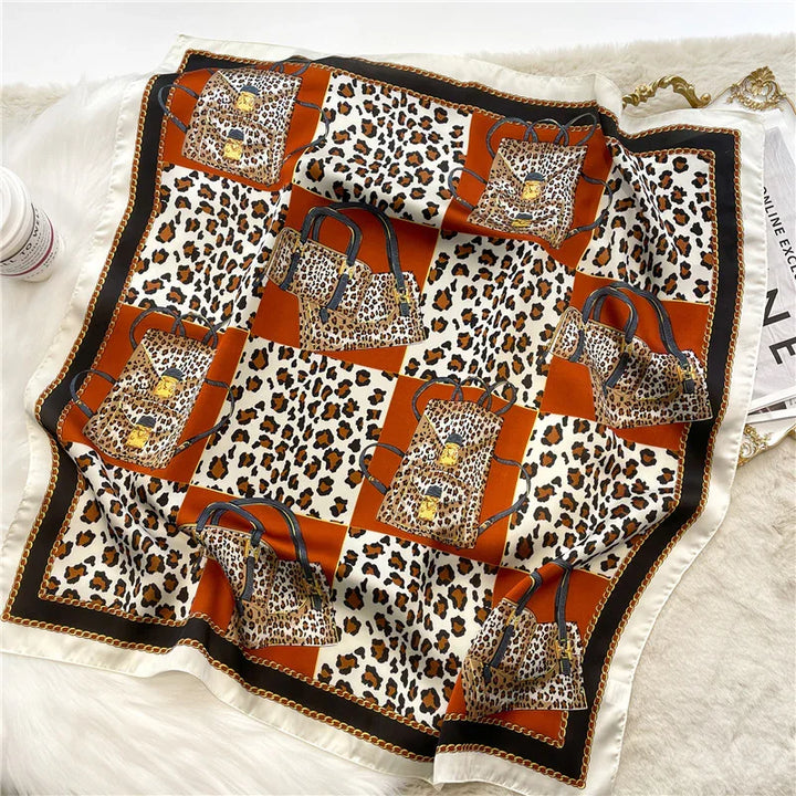 Silk scarf with leopard print and brown handbag pattern on checkered brown and white background