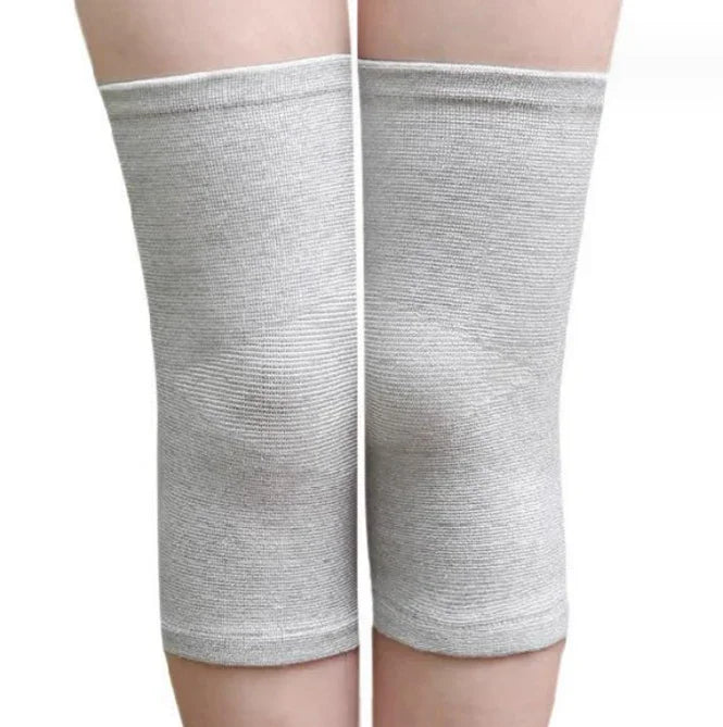 Gray elastic knee sleeves worn on both knees for joint support and compression