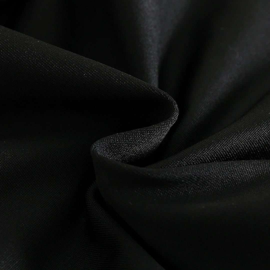 Close-up of smooth black fabric with fine textured weave and soft folds