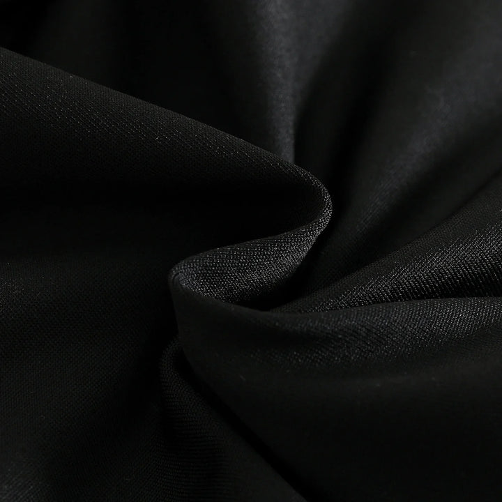 Close-up of smooth black fabric with fine textured weave and soft folds