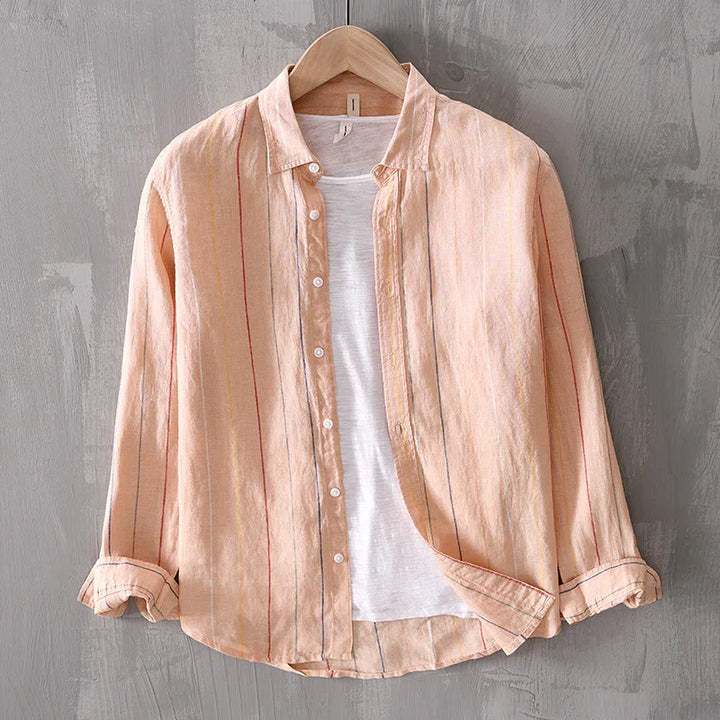Peach striped button-up shirt layered over white t-shirt on wooden hanger against gray wall