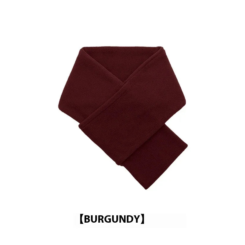 Soft burgundy fleece scarf folded on white background, warm winter accessory