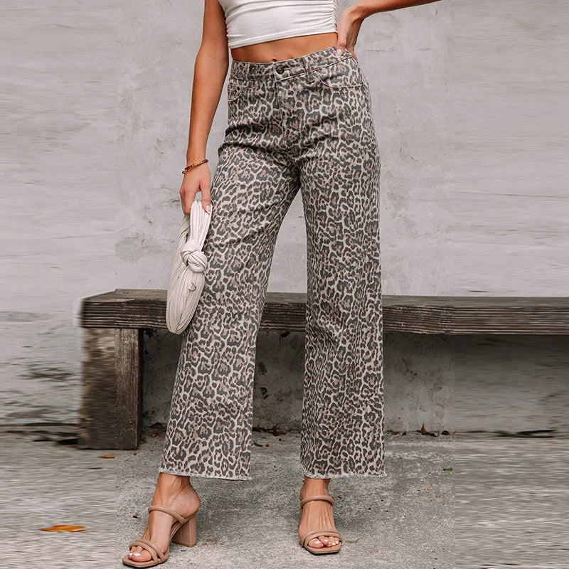 Woman wearing high-waisted leopard print wide-leg pants with beige heels and white cropped top