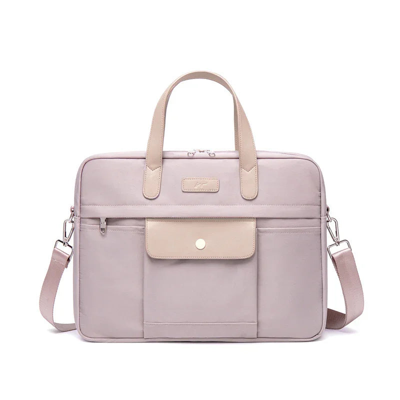 light pink laptop bag with beige handles, front pocket with snap button, and adjustable shoulder strap