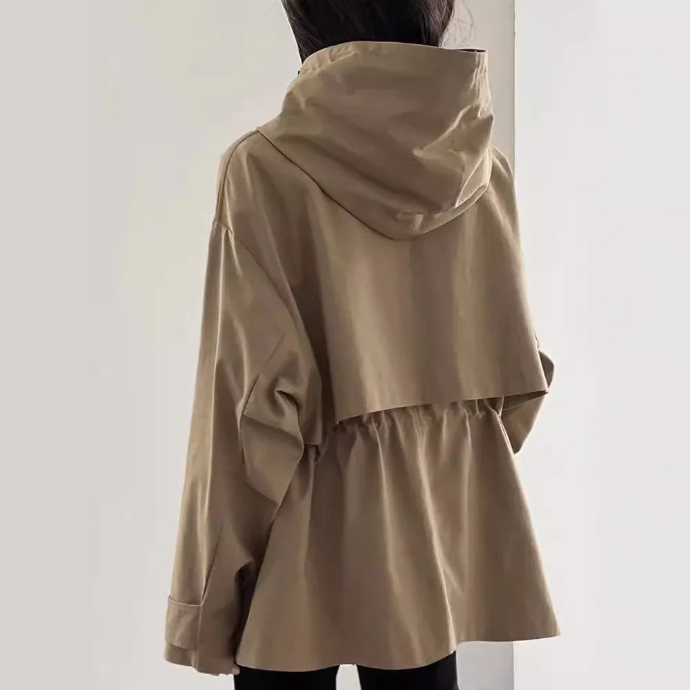 Back view of person wearing oversized beige hooded jacket with gathered waist and long sleeves