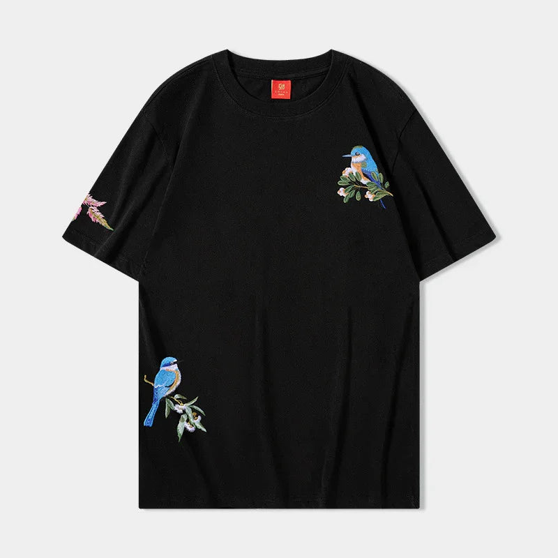 Black short-sleeve t-shirt with embroidered colorful birds and floral designs on front and sleeve