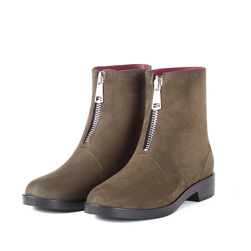 Brown suede ankle boots with front silver zipper and low black heel on white background