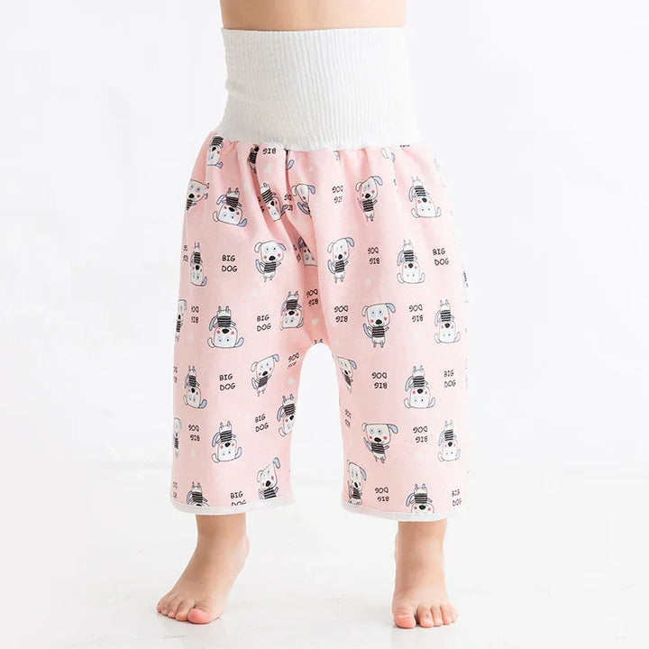 Baby wearing pink pants with white waistband and dog print, standing barefoot on white floor
