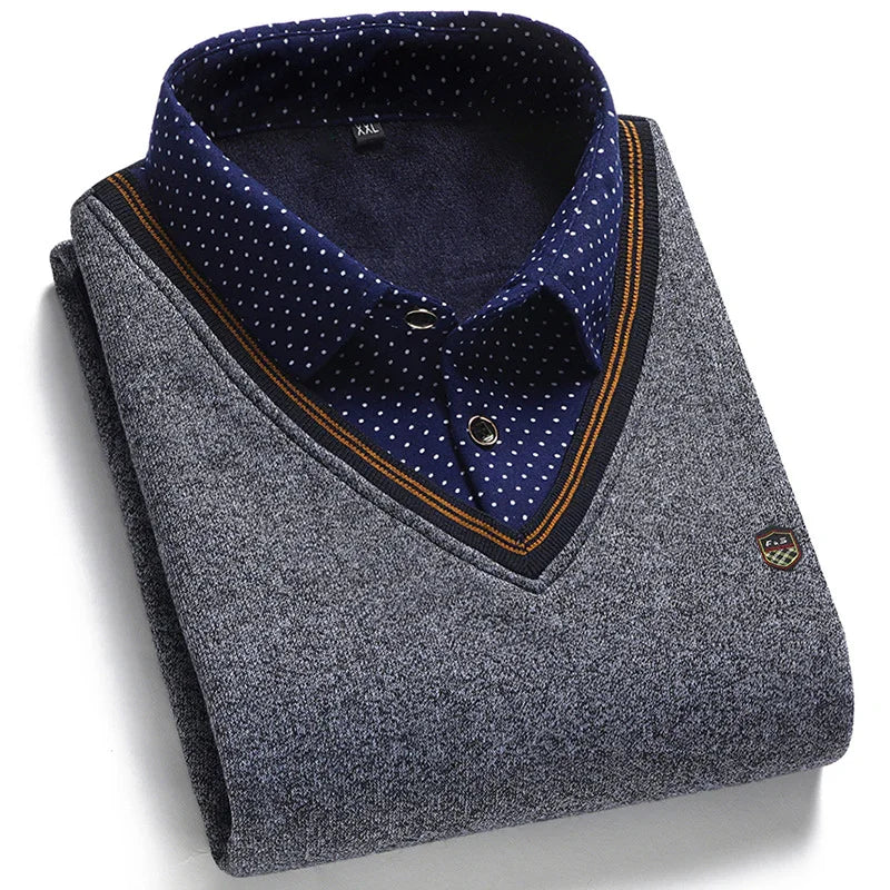 Folded grey V-neck sweater with navy blue and orange trim over a navy blue polka dot collared shirt