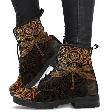 Black lace-up boots with intricate gold and bronze mandala and dragonfly design worn with black pants