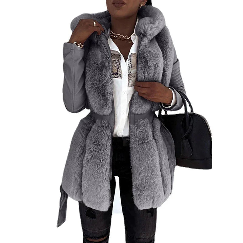 woman wearing stylish gray faux fur coat with belt, white shirt, black ripped jeans, and black handbag