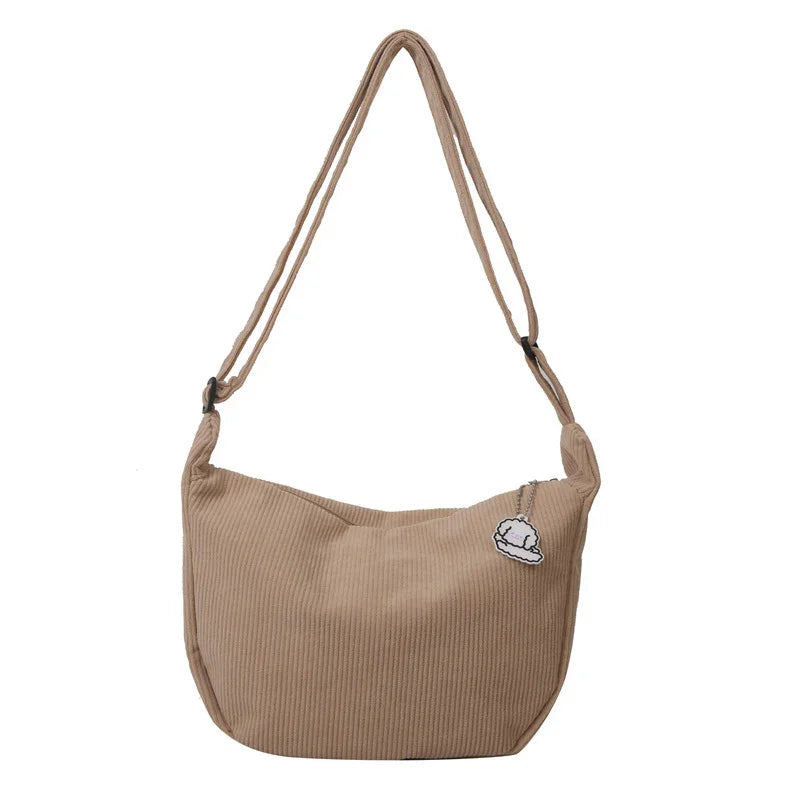 Beige corduroy shoulder bag with adjustable strap and cloud charm accessory